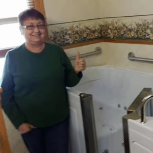 Reida standing next to walk-in tub