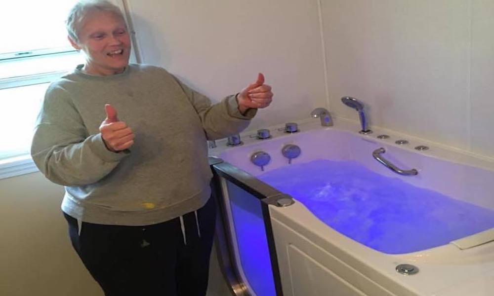 Reida standing next to walk-in tub